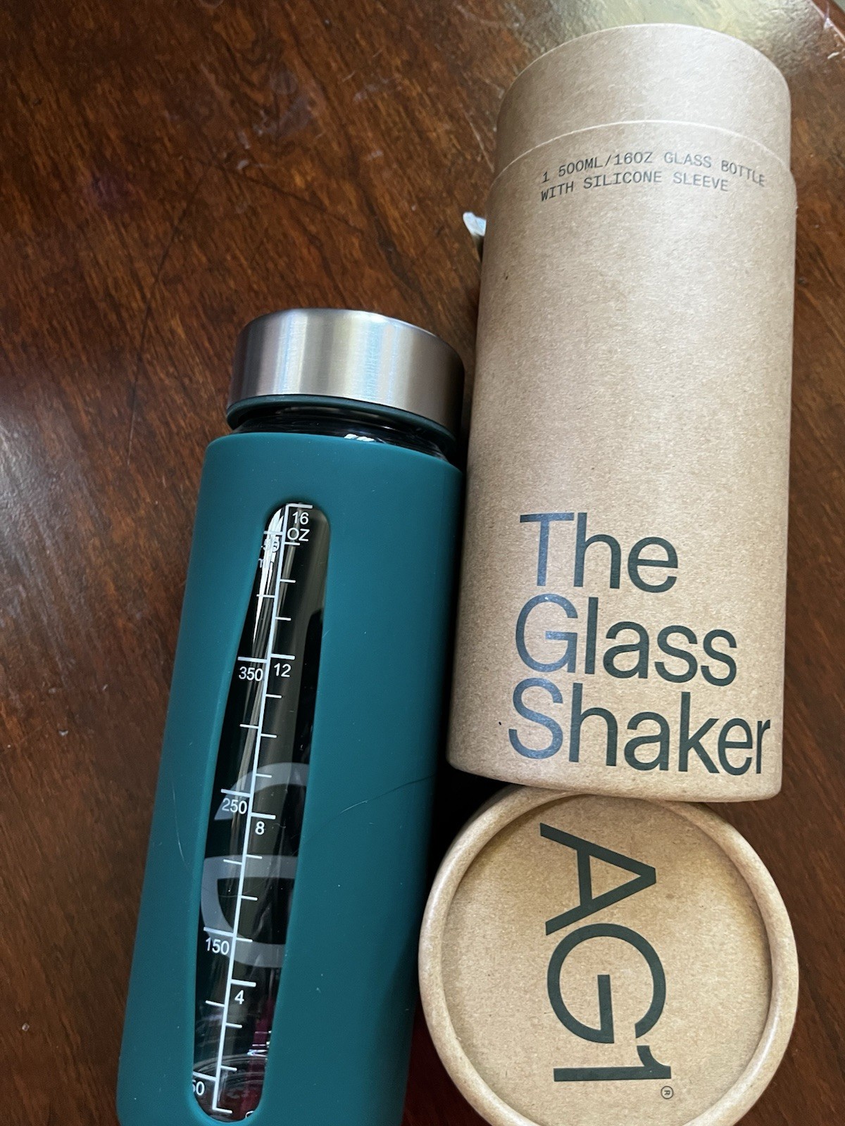 AG1 The Glass Shaker 16 fl oz Glass Bottle Green Sleeve Screw-On Lid, Marks
